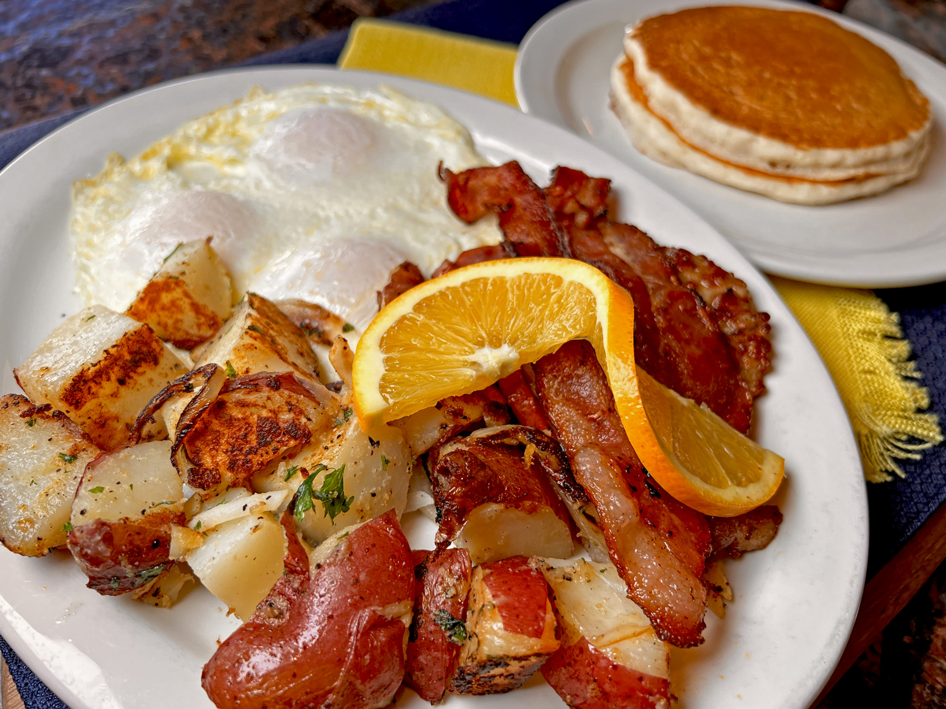 Roested Potatoes With Overeasy Eggs Bacon Pancakes Closeup
